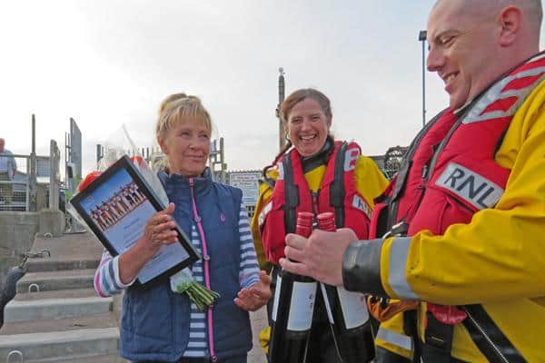 Ailsa Shiel, of Golden Gate Farne Island Boat Trips, was presented with wine and flowers by lifeboat crew Lynsey Carr and Iain Saunders,  in lieu of the company's generous donation.