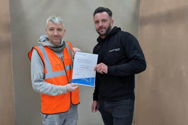 Anthony Slater, left, received his certificate from Pete Baum, skills partnerships manager for British Gypsum. (Photo by Northumberland County Council)