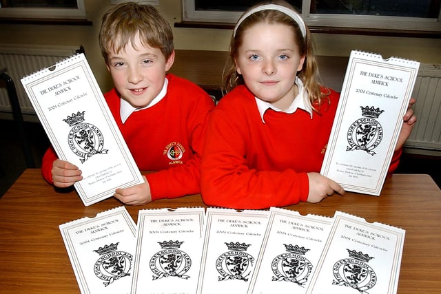 Pupils from the Duke's Middle School in Alnwick, Richard Biggers, 10, and Gemma Gibson, nine, show off the 2004 Centenary Calendars which were on sale at the school.