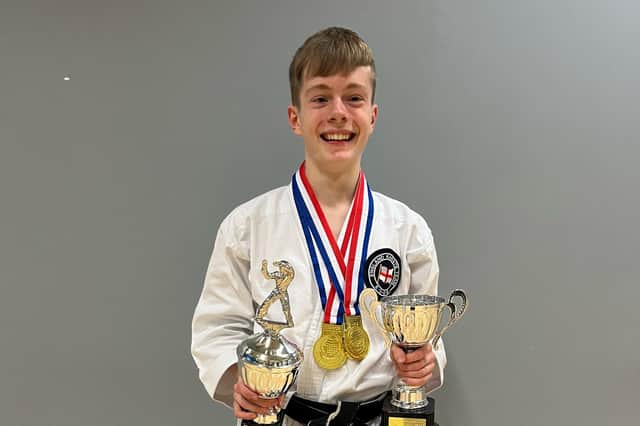 Denny Shy, with his trophies and mnedals from the National Youth Champiuonships.