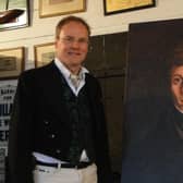 Project director Andrew Ayre with a portrait of John Mackay Wilson.