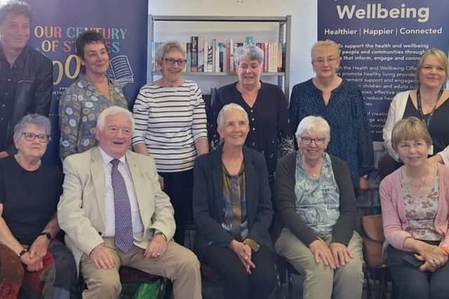 A group photograph at Lynemouth Library including Ann Cleeves, centre in front row.