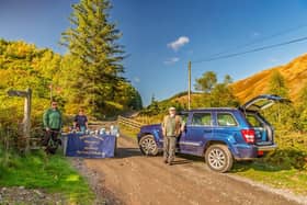 Sue and Rich Hurst meeting customers at Kidland Hill in a recreation of the historic photograph. (Susan Barwood Photography)