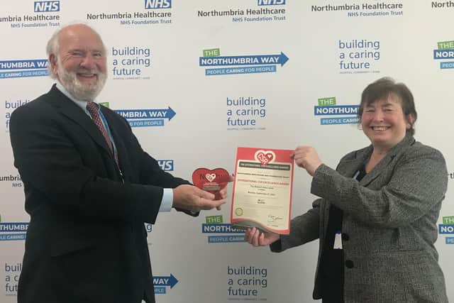 Chair of Northumbria Healthcare NHS Foundation Trust, Alan Richardson presenting the award to Margaret Robertson, project deaf awareness co-ordinator for the trust.