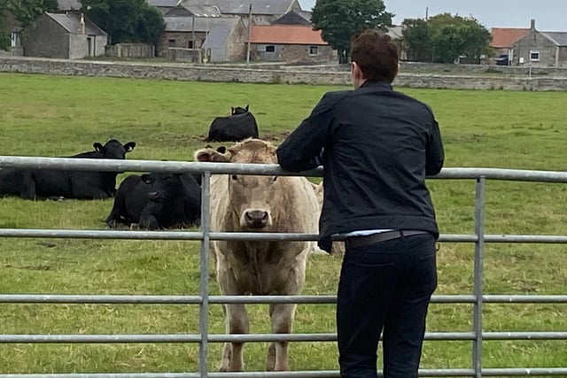 Kenny Doughty, who plays DS Aiden Healy, takes time out to meet one of the inhabitants of Boulmer village, one of the scenes for series 11 of the popular ITV crime drama Vera.