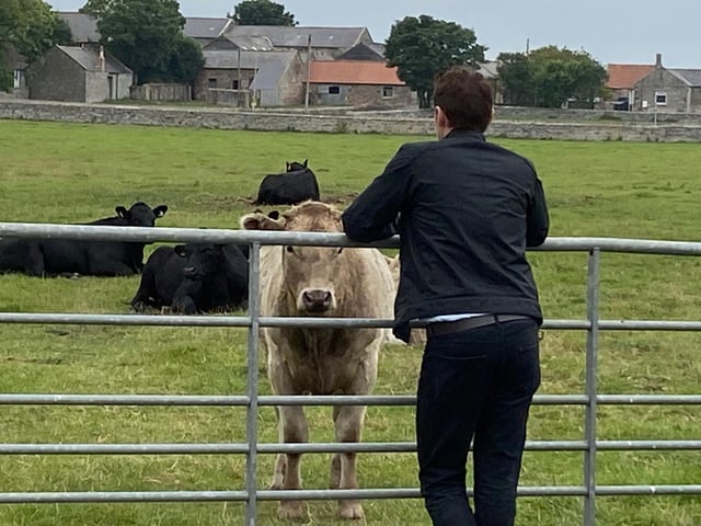 Kenny Doughty, who plays DS Aiden Healy, takes time out to meet one of the inhabitants of Boulmer village, one of the scenes for series 11 of the popular ITV crime drama Vera.