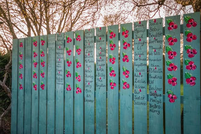 Hand-painted poppies on the remembrance fence in Longhoughton.