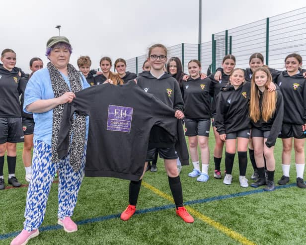 Elizabeth Humphreys presents hoodies to Alnwick Town Juniors U15 girls. Picture: Brian Young