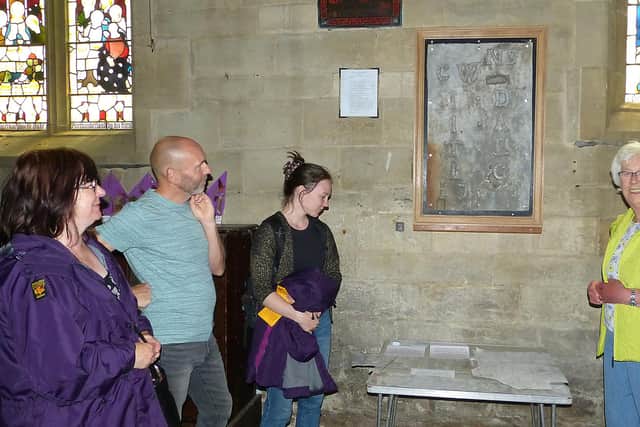 Bridget, John and Hannah, visitors from Sheffield, examine some of the graffiti with Jean Darby (project coordinator).