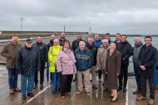 Councillors, Environment Agency staff and other stakeholders involved in the project at Seahouses pier.