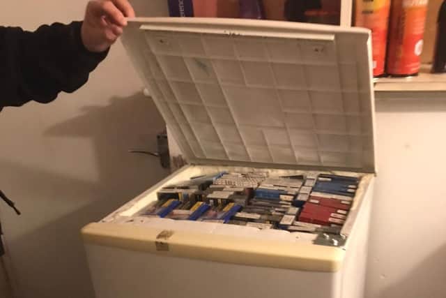 The illegal cigarettes found hidden in a fridge during the raids.