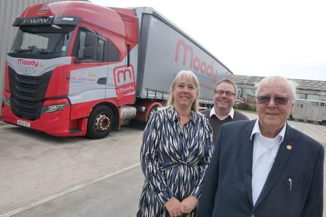 Caroline Moody (left), operations director Richard Moody (centre), and chairman Alan Moody (right) with one of the new Iveco S-Ways which bears the company's 75th anniversary logo.
