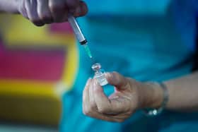 A doctor draws up the Pfizer-BioNTech vaccine at a pop-up vaccination centre. Picture: Ian Forsyth/Getty Images.