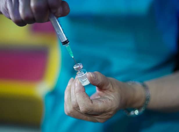 A doctor draws up the Pfizer-BioNTech vaccine at a pop-up vaccination centre. Picture: Ian Forsyth/Getty Images.