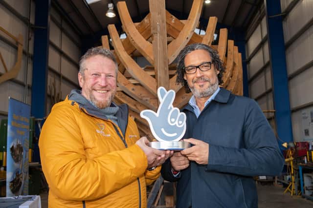 A delighted Clive Gray receives his Heritage Lottery award from broadcaster and historian David Olusoga.