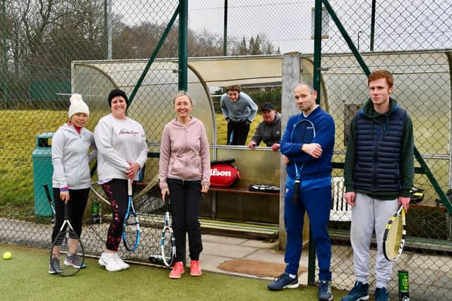 Members of Morpeth Tennis Club pictured during a social session on Saturday next to the storm-damaged dugout.