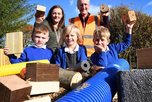 Demi Chandler, year one and year two teacher (back left) and Gary Coils, construction director at Amethyst Homes (back right), with Cambois Primary School pupils.