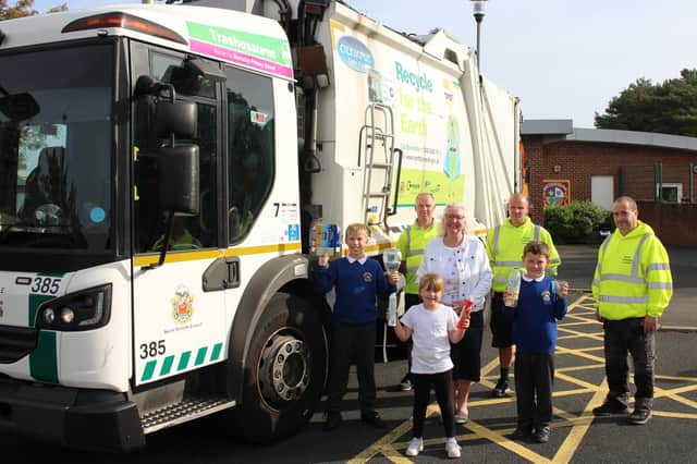 Coun Sandra Graham, Cabinet Member for the Environment (centre), with the crew of a recycling wagon and children from Burradon Primary School (L-R) Nathan Anderson, aged 10; Lexi Anderson, aged six; and Thomas Round, aged eight.