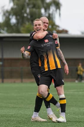 Jack Foalle celebrates his goal, Morpeth Town's fourth, with captain Jeff Henderson. Picture: George Davidson