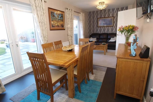 The dining room is part of an open plan kitchen, dining and family room area, with access to the rear garden.