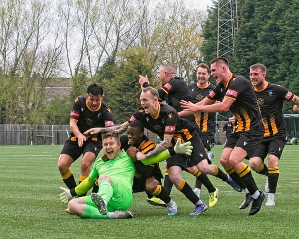 Dan Lowson is mobbed by his team-mates after scoring in the 95th minute. Picture: George Davidson