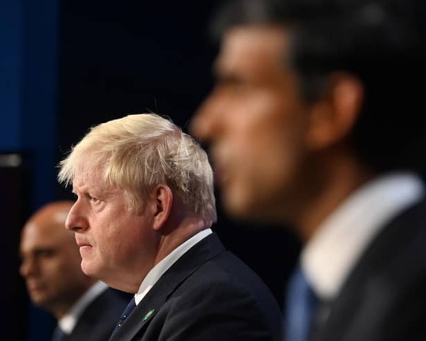 Boris Johnson flanked by Sajid Javid and Rishi Sunak who have both resigned from the cabinet