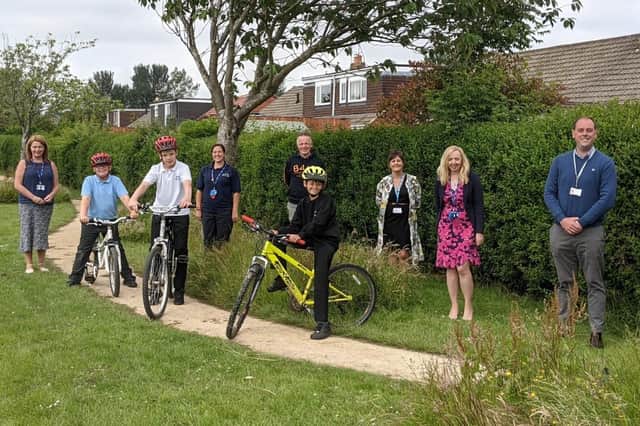 Adults pictured, from left, Susan Major, deputy headteacher,  PE teacher Mrs Davidson, David Buchan, Bike4Health, Jill Harland, consultant in public health, Gillian Linkleter, headteacher, and Coun Guy Renner-Thompson. Also pictured are three Collingwood School and Media Arts College pupils.