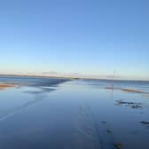 Two people and a dog were rescued after their vehicle got stuck on Holy Island causeway. Picture: Barrie Corden