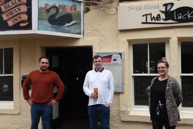 Black Swan customer James Armstrong with owner Scott Doherty and manager Sophie Browell.