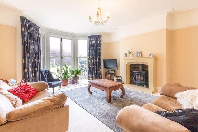 The traditional drawing room has fabulous full length sash style windows to a walk in large bay overlooking the gardens.