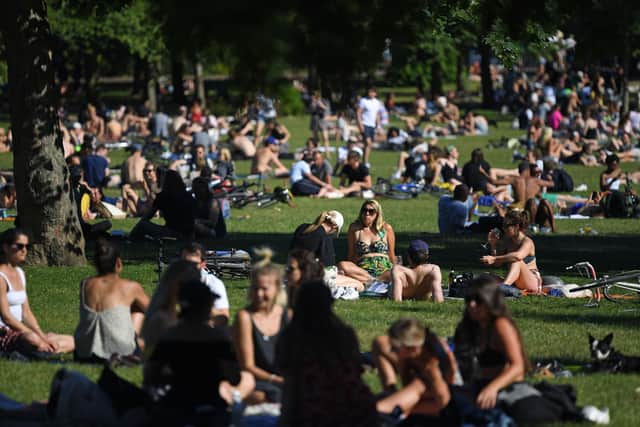 People enjoy the sunshine in London on Saturday May 30 ahead of the coming into force of the first significant easing of Britain's lockdown measures during the coronavirus pandemic. Picture: AFP via Getty Images.