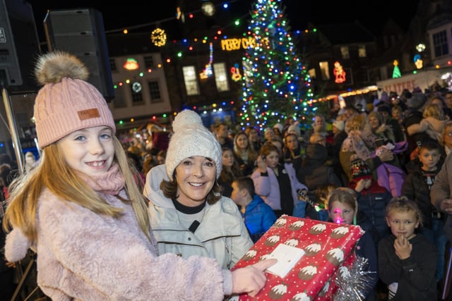 Millie Rae O’Neill switches on the Alnwick lights watched by the Duchess of Northumberland.