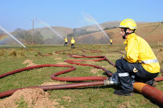 Northumberland Fire and Rescue Service at the Breamish Firepond on the Linhope Estate demonstrating how high volume pumps can be used to combat wildfire in the Cheviots.
