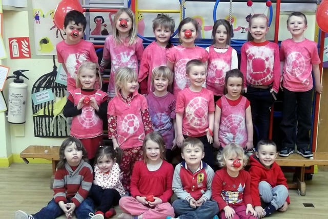 Tritlington children celebrating Red Nose Day in 2013 wearing their red noses and red tie dye T-shirts which they made in school as part of their learning about Africa.