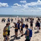 Coastal Run competitors gather before the start at Beadnell Beach.