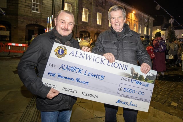 Alnwick Lions president Matt Lawless handing over £5,000 to lights committee chairman Gordon Castle.