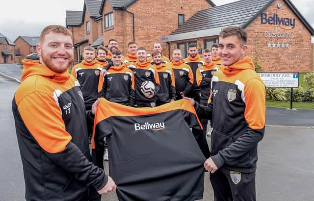 The Blyth Rangers first team outside Bellway’s Woodgreen development, with Captain Dan Burge and player Kieran Swann showing off their new, Bellway sponsored hoodies.