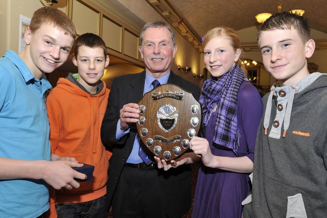 Duchess's High School cross country runners Connor Weightman, Joe Mallen, Jess Morrison and Phil Winkler accept the Junior Team Award from Tim Mason of the Rotary Club of Amble and Warkworth.