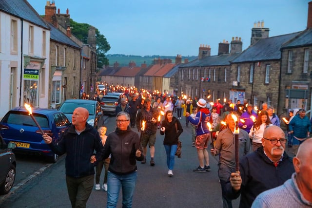 A torchlight procession through Belford.