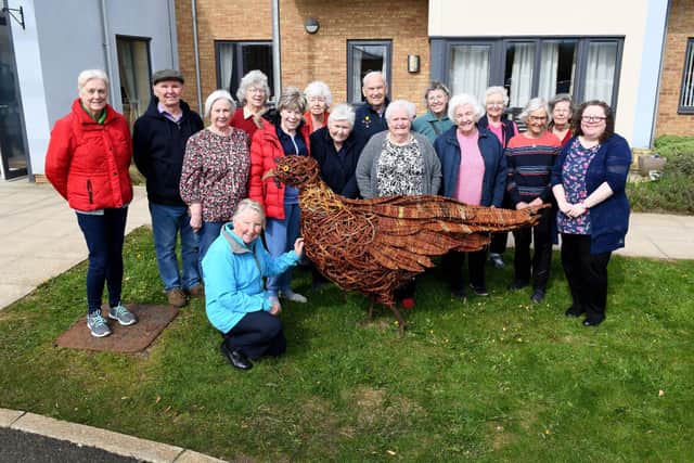Residents at Weavers’ Court with their newly restored pheasant mascot.