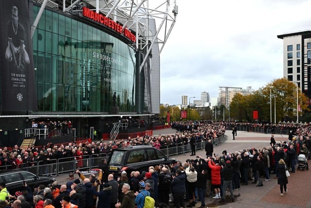 A hearse carrying the coffin of England World Cup winner and Manchester United legend Bobby Charlton is driven past Old Trafford stadium ahead of his funeral in Manchester. (Photo by Oli SCARFF / AFP) (Photo by OLI SCARFF/AFP via Getty Images)