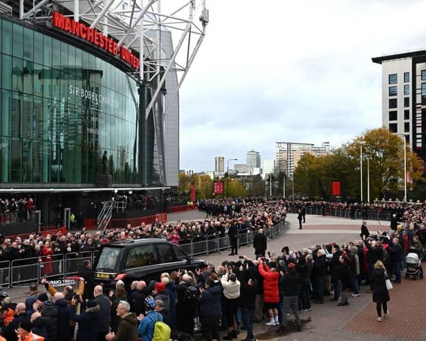 A hearse carrying the coffin of England World Cup winner and Manchester United legend Bobby Charlton is driven past Old Trafford stadium ahead of his funeral in Manchester. (Photo by Oli SCARFF / AFP) (Photo by OLI SCARFF/AFP via Getty Images)