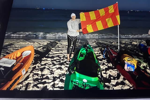 Chris Ormston with the Northumberland flag in Perth, Australia.