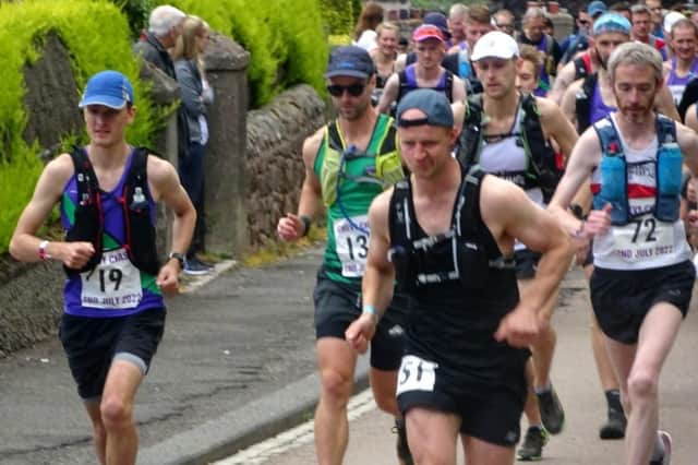 The Chevy Chase gets under way in Wooler with race winner Jarlath Mckenna (72), right, and Harriers' Matthew Briggs, left.