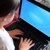 Row flares over schools laptop provision.