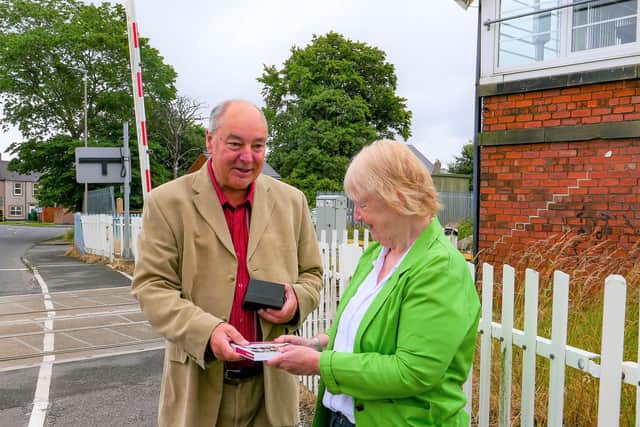 SENRUG Chair Dennis Fancett receives the award from Railfuture Passenger Director Allison Cosgrove at Bedlington Station.