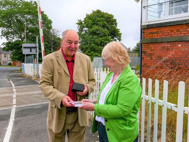 SENRUG Chair Dennis Fancett receives the award from Railfuture Passenger Director Allison Cosgrove at Bedlington Station.