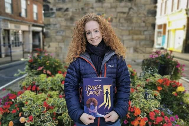 Lou Coel pictured with a copy of her new book in Morpeth.