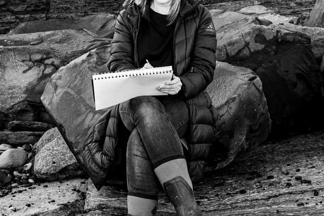 Katherine Renton sketching on the Northumberland coast. 
Photo: Jim Donnelly