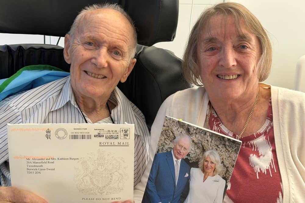 Alexander and Kathleen Burgon with the card from the King and Queen.